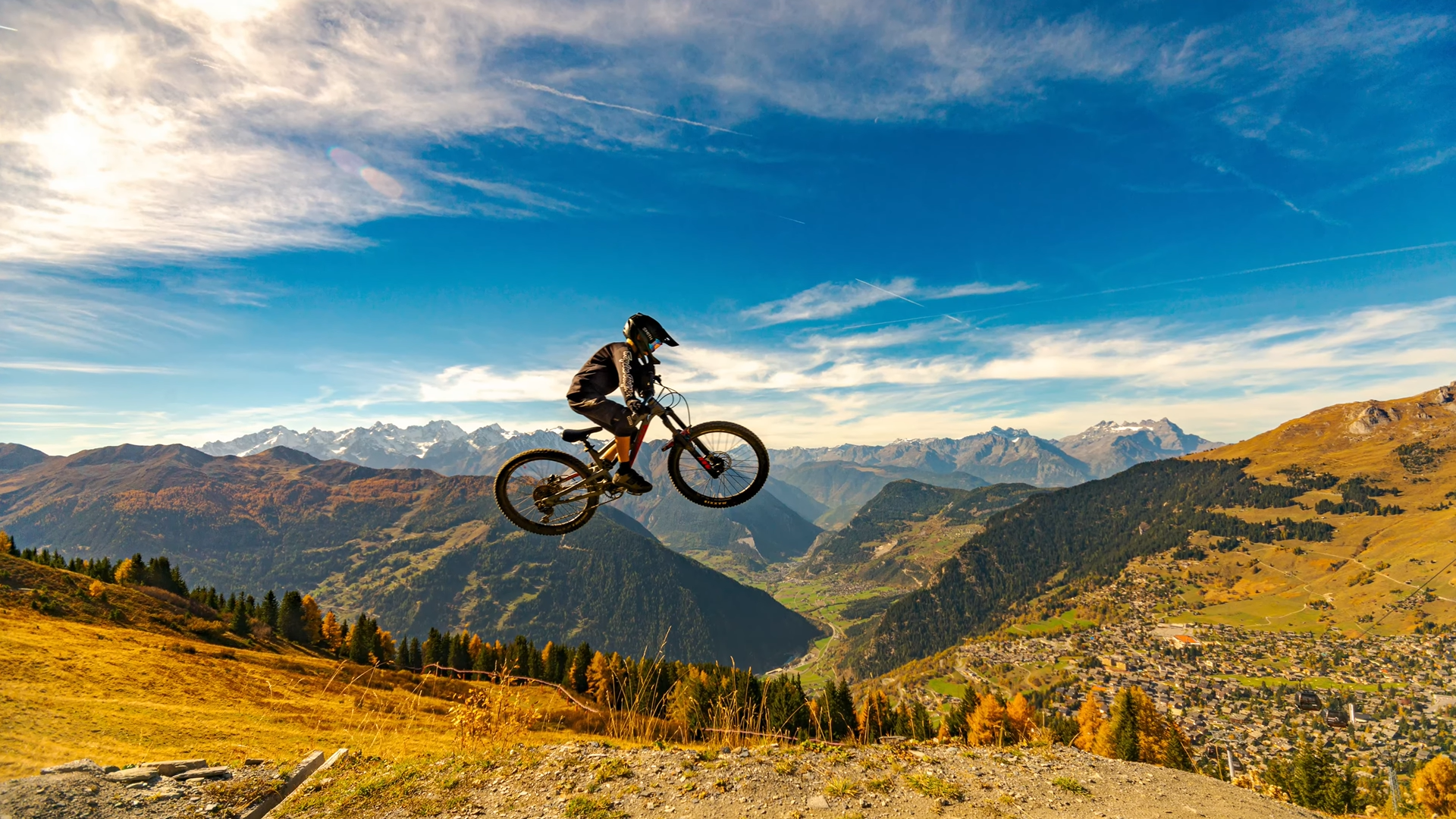 Mountain biker jumping above the Verbier valley