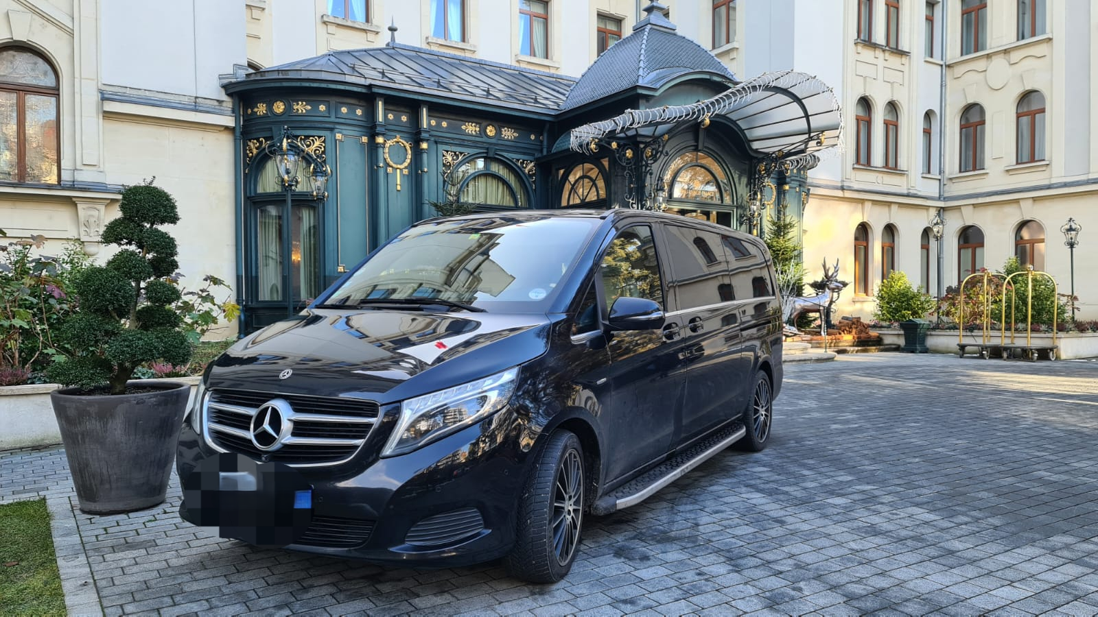Luxury Mercedes van at hotel entrance