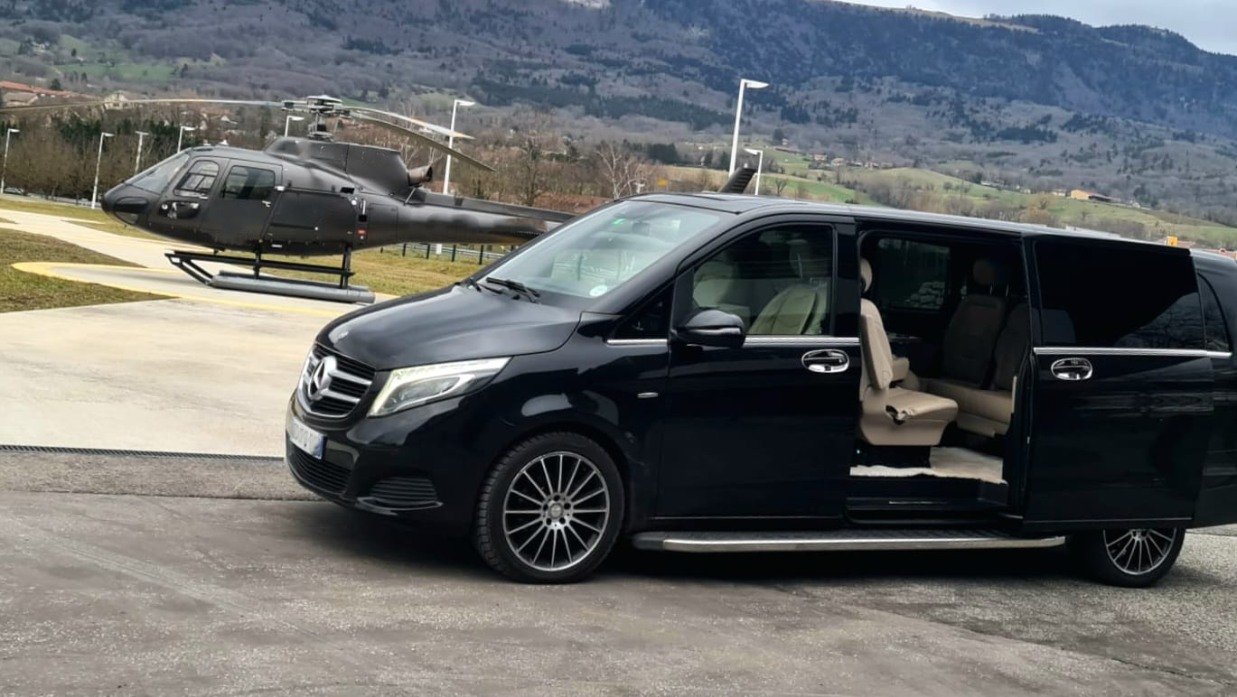 Luxury airport transfer van with helicopter on helipad